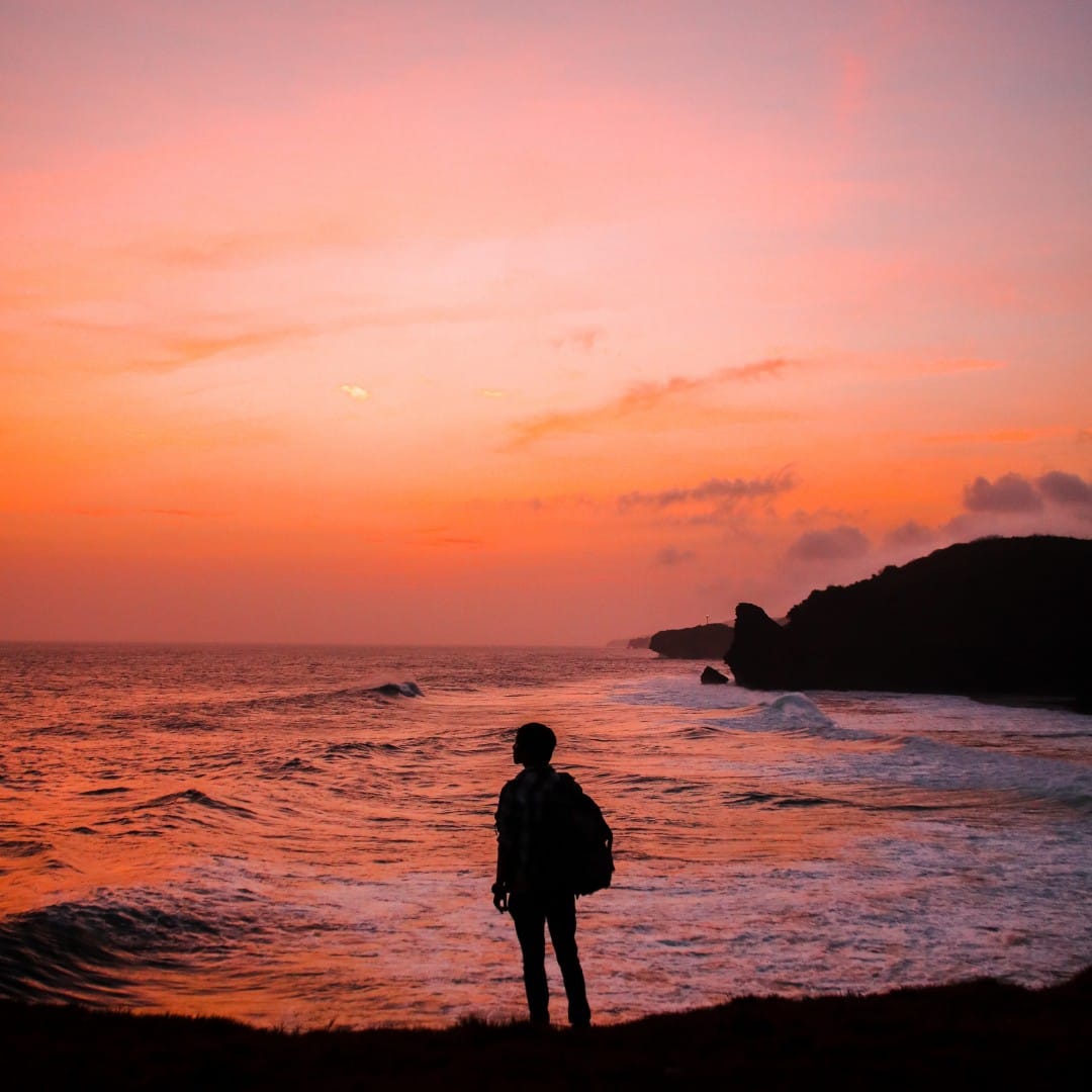staring into sunset at beach