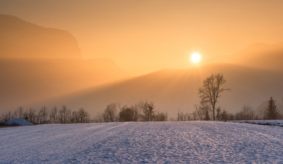 sunrise with snow on ground