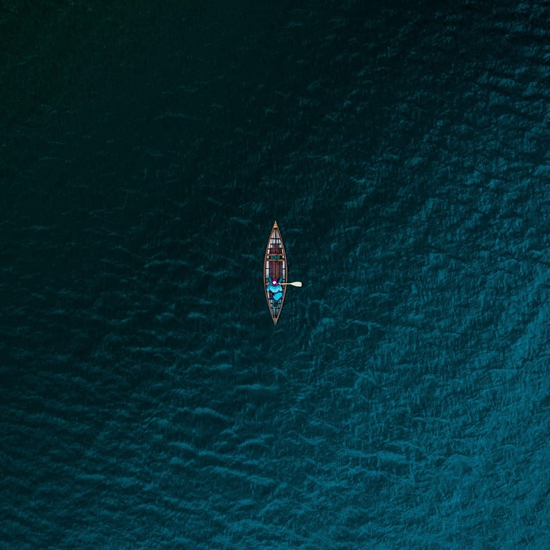 man in boat on ocean