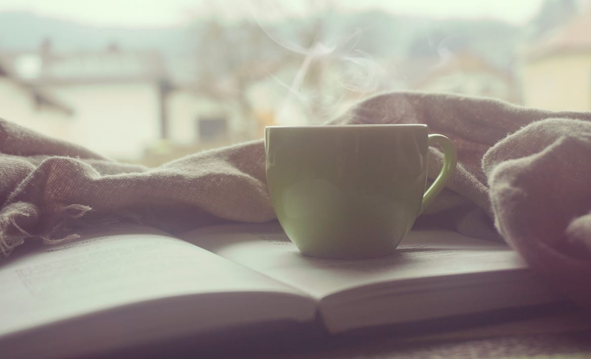 steaming coffee cup with bible