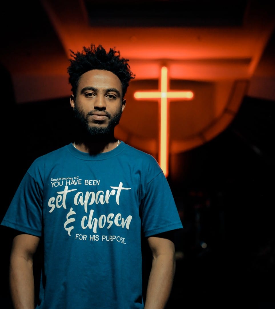 man standing in front of cross