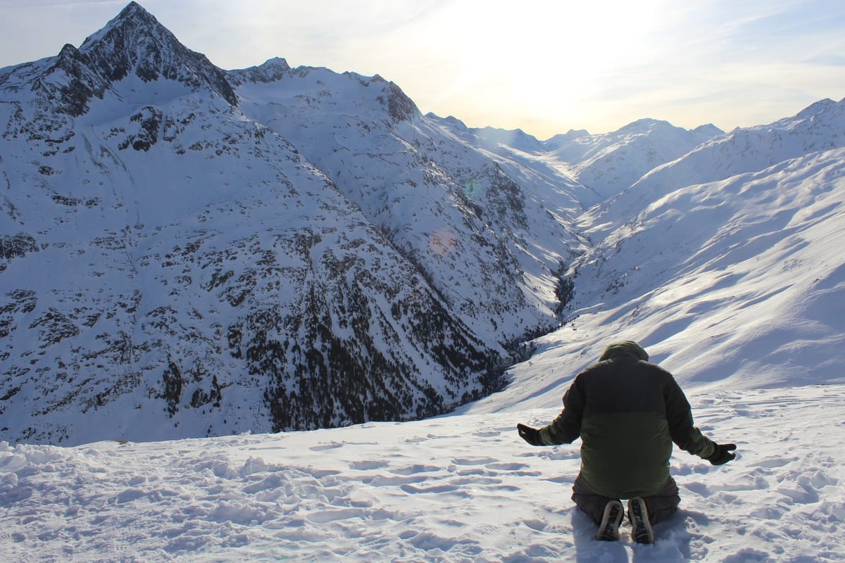 man on mountains kneeling and bowing knee