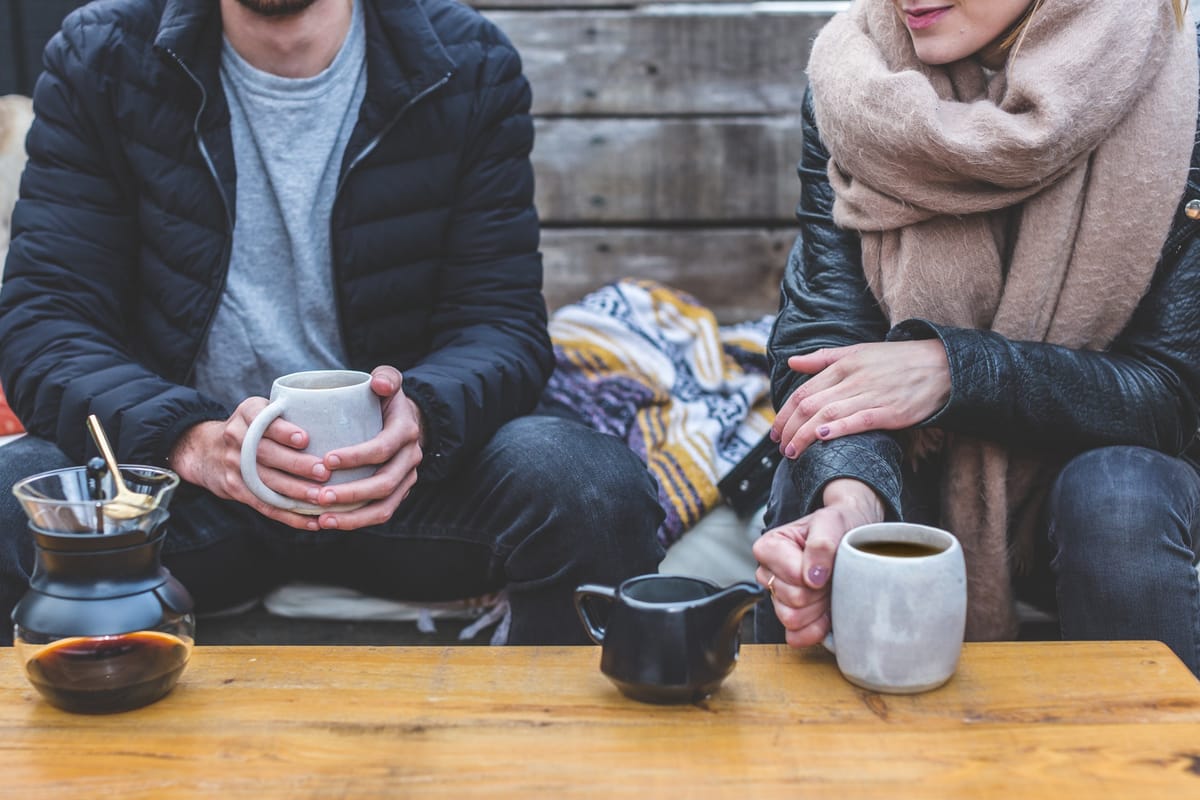 man and woman having coffee