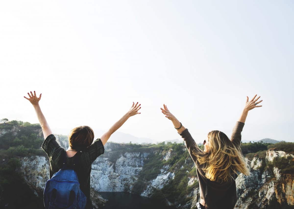 women with arms in the air