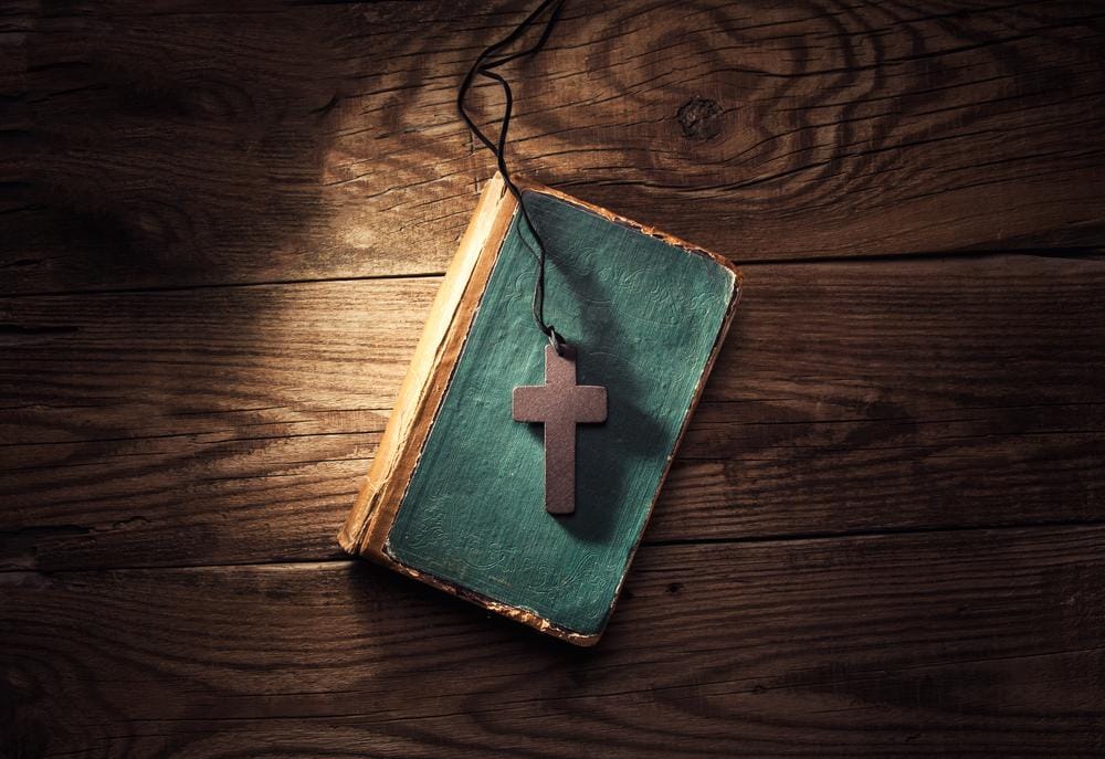 bible with wood cross on it