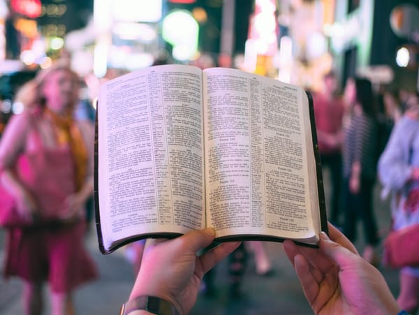 holding bible in crowd