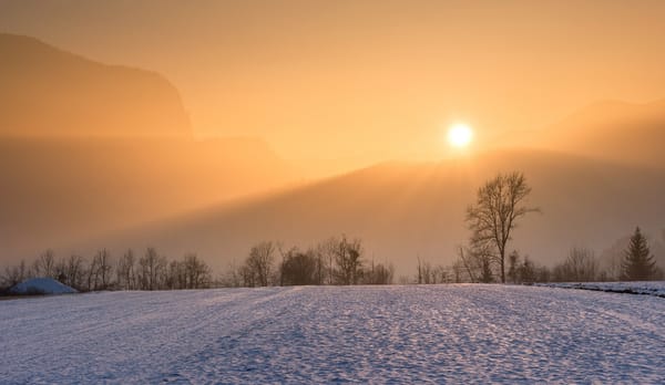sunrise with snow on ground