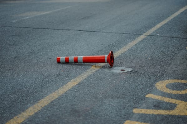 orange road construction cone in road