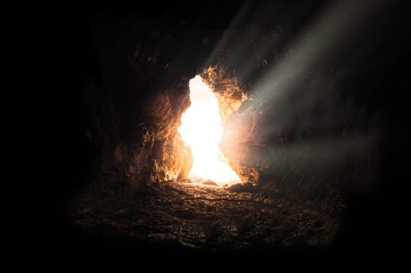 Inside cave looking out light shining in He has risen