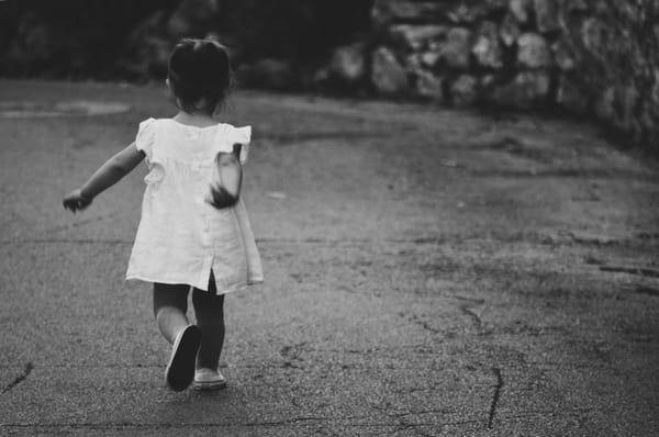 little girl running in street