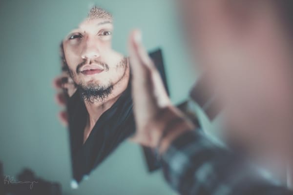 man looking in poor mirror