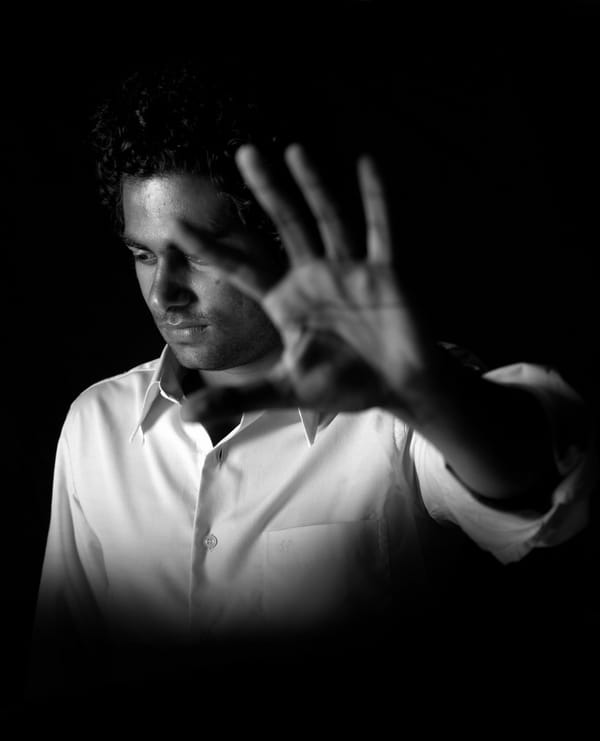 man with hand up