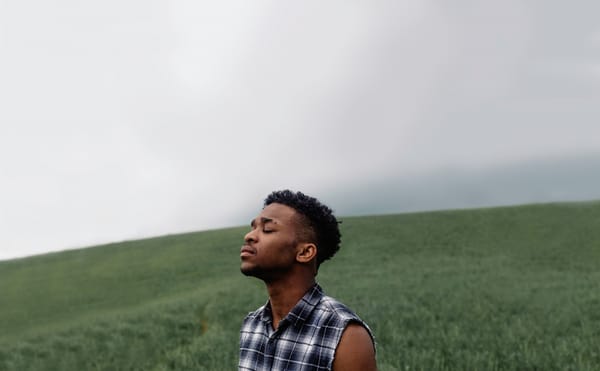 man in field looking up