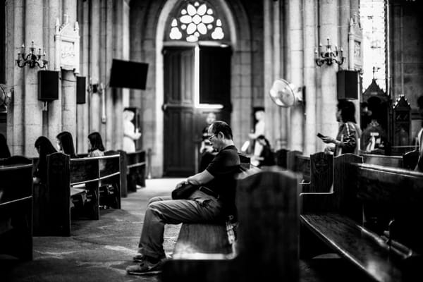 man sitting in church listening