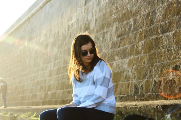 woman sitting against wall