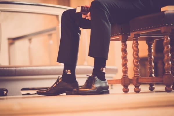 biblical man sitting on pew