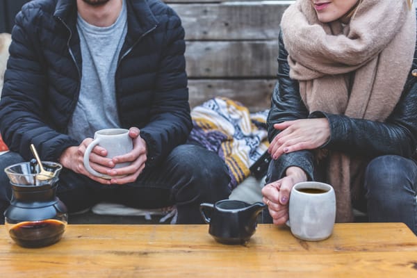 man and woman having coffee