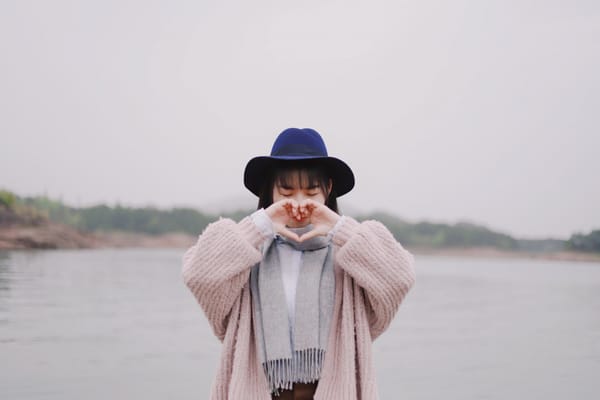 woman making heart sign