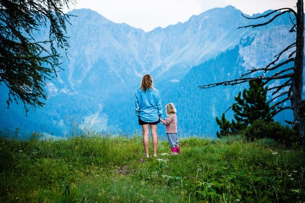 mom and daughter looking at mountains