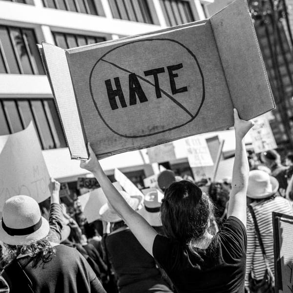woman holding no hate sign