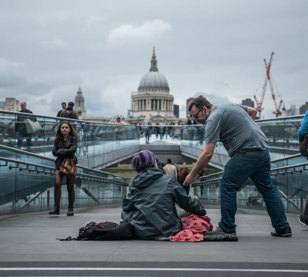 man helping homeless person
