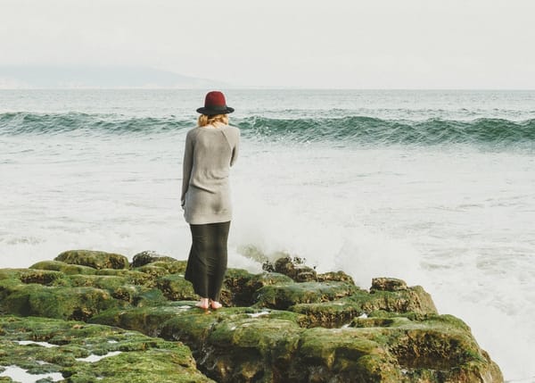 woman standing on rocks