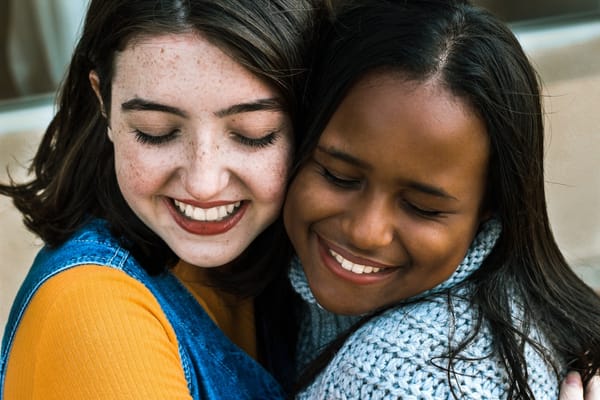 women hugging and forgiving