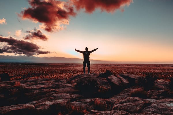 man praise lifted arms